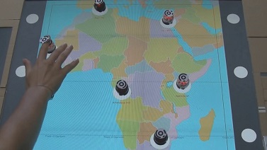 Picture of Botmap, a system with a tabletop display showing a US map with Ozobots (small robots) on top