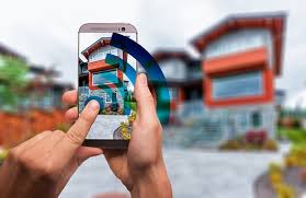 A person holding a smartphone and pointing its camera to a building.
