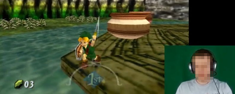 screenshot taken from the video game 'The Legend of Zelda: Majora's Mask'. The image shows the playable character, Link, swinging his sword besides a big pot in a swamp-like scenario. The player’s webcam is seen in the corner of the image, but their face is pixelated (anonymized).